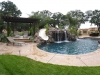 freeform pool with rock slide and waterfall